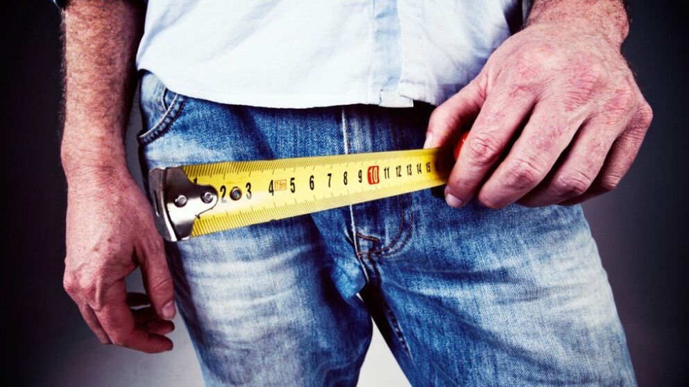 man measuring penis after gel enlargement